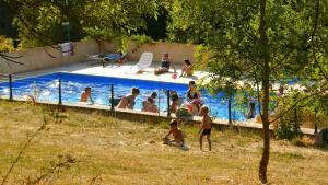 a group of people playing in a swimming pool at Domaine la butte de Lauray in Moncontour-de-Poitou