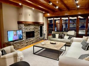 a living room with a couch and a fireplace at GESSA, VAL d'ARAN in Gessa