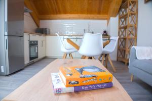 two books sitting on a table in a kitchen at Via de la Plata Luxury Suites 2C in La Bañeza