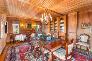 a dining room with a wooden table and chairs at The Castle Bed And Breakfast in Ocracoke
