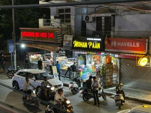 a group of people riding motorcycles on a city street at SREA Homestead Dormitory in New Delhi