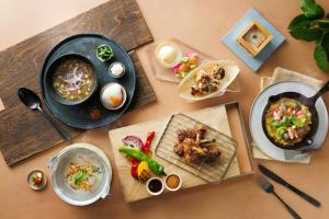 a table with plates of food and bowls of food at Courtyard by Marriott Shin-Osaka Station in Osaka