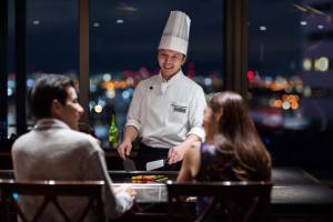 a chef standing in front of a group of people at Courtyard by Marriott Shin-Osaka Station in Osaka