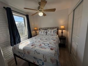 a bedroom with a bed and a ceiling fan at Unit 109 -1br Apt Oceanfront Complex With Pool in Cocoa Beach