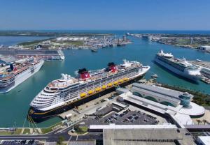 a cruise ship docked in a harbor with other cruise ships at Unit 109 -1br Apt Oceanfront Complex With Pool in Cocoa Beach