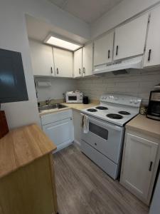 a kitchen with a white stove and a sink at Unit 109 -1br Apt Oceanfront Complex With Pool in Cocoa Beach