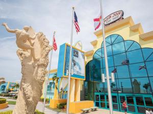 a statue of a woman in a dress in front of a building at Unit 109 -1br Apt Oceanfront Complex With Pool in Cocoa Beach