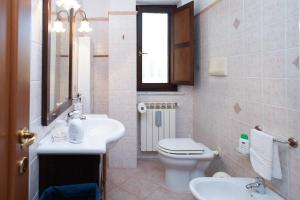 a bathroom with a sink and a toilet and a mirror at Xenia in Castrovillari