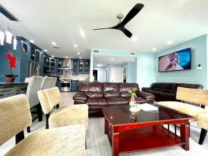 a living room with a couch and a ceiling fan at Fam Reunion, Beachview, EV charger Heated Pool, Jacuzzi, Billiard in South Padre Island