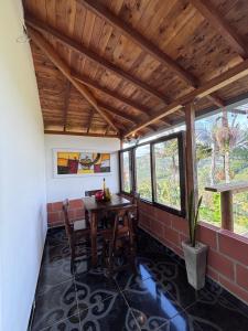 a dining room with a table and chairs at Mayka cabañas con JACUZZI in Guatapé