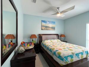 a bedroom with a bed and a dresser and a mirror at Fam Reunion, Beachview, EV charger Heated Pool, Jacuzzi, Billiard in South Padre Island +53 photos