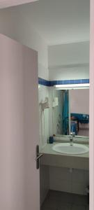 a bathroom with a sink and a mirror at TOUMALACAÏ Appart 245 in Folle Anse