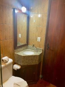 a bathroom with a sink and a toilet and a mirror at iapôi Beira-Mar Maracaípe in Porto De Galinhas +50 photos