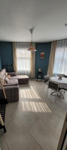a living room with a couch and a table at Dokstudio50 in Ghent