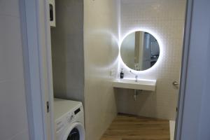 a bathroom with a sink and a mirror at Ruzafa Alegria in Valencia +11 photos