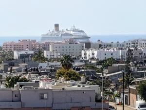 a cruise ship in a city with buildings at Cabo Condos - Boutique Condos in Cabo San Lucas