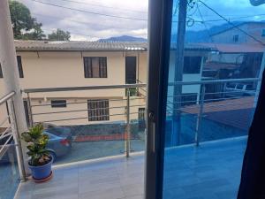 an open door to a balcony with a view of a house at Apartamento en La Colina in Macanal