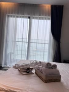 a bed with towels on it with a window at Mian Sapphire Home toà S1 S2 in Ha Long +291 photos