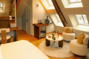 a living room with two chairs and a table at FÓLKLORE Boutique Hôtel in Sancerre