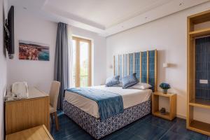 Postel nebo postele na pokoji v ubytování Relais San Francesco