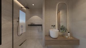 a bathroom with aanding tub and a sink at NAMA Suites in Limín Khersonísou