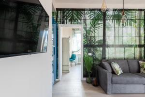 a living room with a couch and some plants at COMO BELLEVUE BORGHI in Como