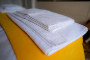 a pile of white towels sitting on top of a bed at Claire Apartment with Garden in Sofia +19 photos