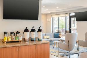 a living room with wine bottles on a counter at TownePlace Suites by Marriott Jackson Ridgeland/The Township at Colony Park in Ridgeland