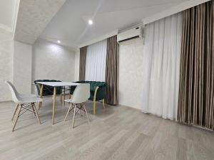 Un comedor con mesa y sillas en Modern comfort appartment, en Salor Bekati