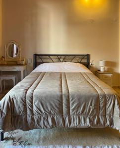 a large bed in a bedroom with a mirror at Στούντιο Κέντρου Άνω πόλης Πάτρας in Patra