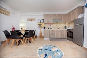 a kitchen and dining room with a table and chairs at LUNA'S HOUSE in Asprovalta