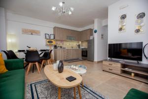 a living room with a couch and a table and a kitchen at LUNA'S HOUSE in Asprovalta +22 photos