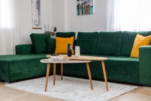 a green couch with a coffee table in a living room at LUNA'S HOUSE in Asprovalta