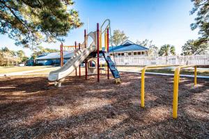 a playground with a slide in a park at Harbourside II Condos in New Bern