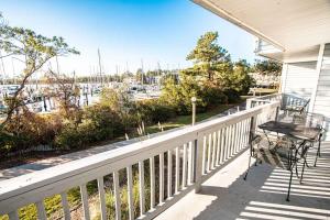 a balcony with a table and chairs and a marina at Harbourside II Condos in New Bern