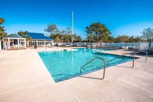a swimming pool with a metal railing in a yard at Harbourside II Condos in New Bern