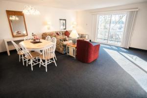 a living room with a table and chairs and a couch at Harbourside II Condos in New Bern