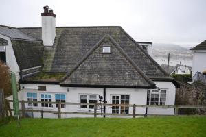 a large white house with a roof at Lighthouse Cottage, 19 Broadlands, Shaldon in Shaldon