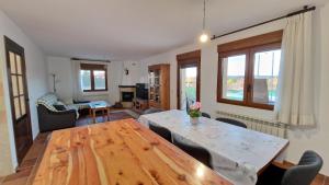 a living room with a wooden table and chairs at La finca de Casa Botes in Cuenca