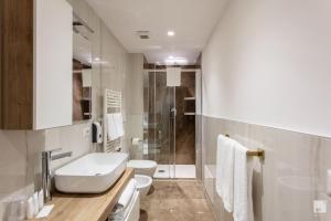 a bathroom with a toilet sink and a shower at Design Suite in Historical Palace in Bologna