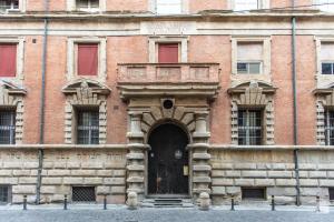 an old brick building with a door in front at Design Suite in Historical Palace in Bologna +7 photos