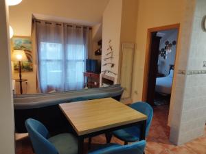 a living room with a table and chairs and a bed at Montaña & relax in La Virgen de la Vega