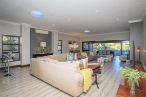a living room with a couch and a table at Lakeview@Pecanwood in Hartbeespoort