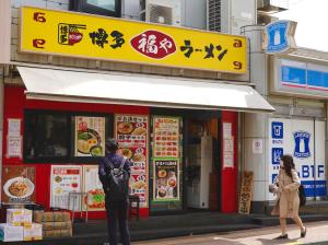 a man standing in front of a restaurant at Home Story in Tokyo Ueno&Uguisudani-小島ビル&東京屋語 in Tokyo