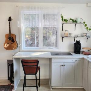 a kitchen with a white counter and a window at Old Library Lodge in Killaloe Station
