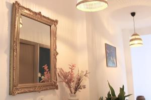 uno specchio d'oro decorato su una parete in una stanza di Casa Fidela by SIERRA VIVA a Cortelazor