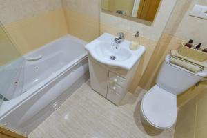 a bathroom with a sink and a toilet and a bath tub at Magic Sunset View in El Borseral +11 photos