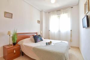 a bedroom with a bed and a window at Magic Sunset View in El Borseral