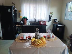 a table with a plate of bananas and a pineapple on it at ALOHA#Sossego in Ubatuba +64 photos