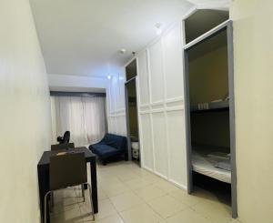 a room with a desk and a room with a bedroom at ACE Condo in Cebu City